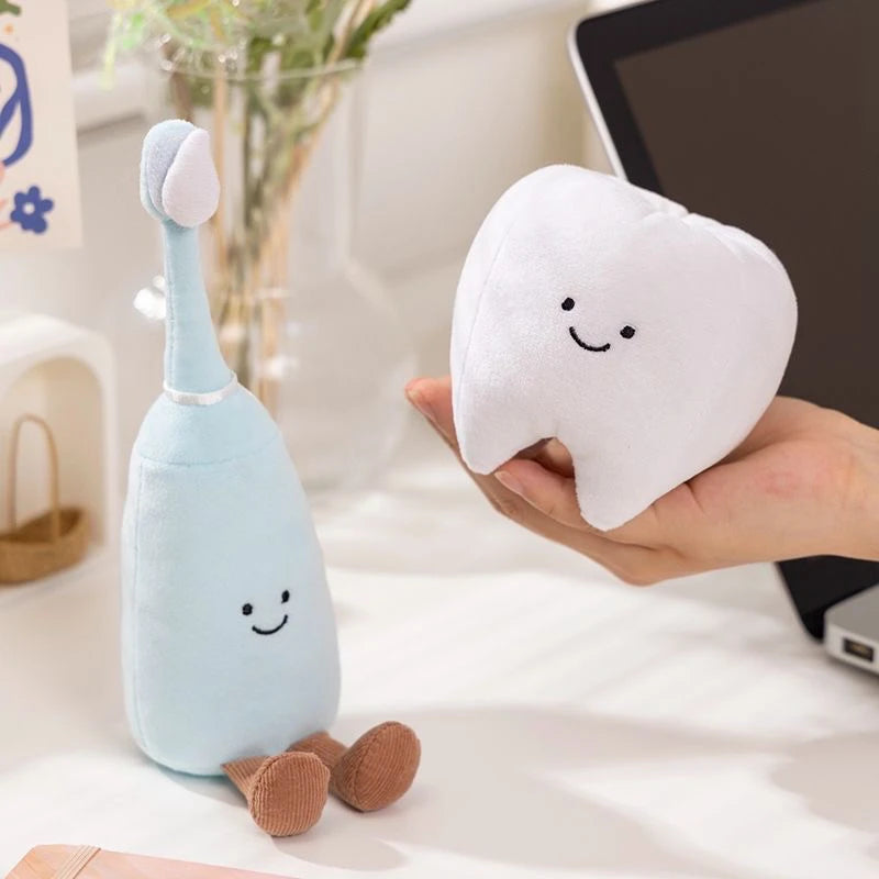 Cute dentist doll with a toothbrush and tooth plush toys promoting fun dental care for kids.
